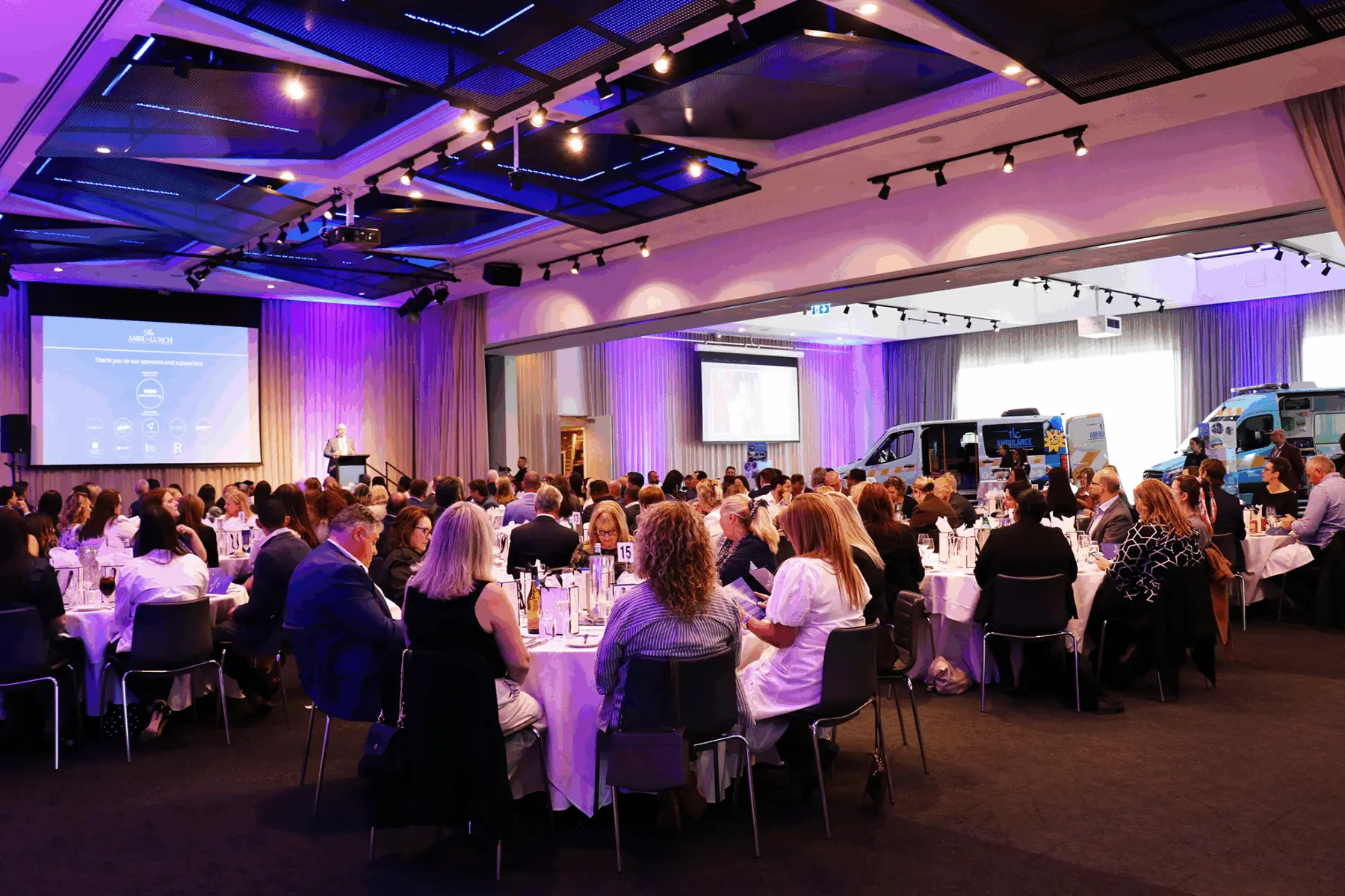 Guests gathered at The Ambu-Lunch with TLC Ambulances displayed inside the venue